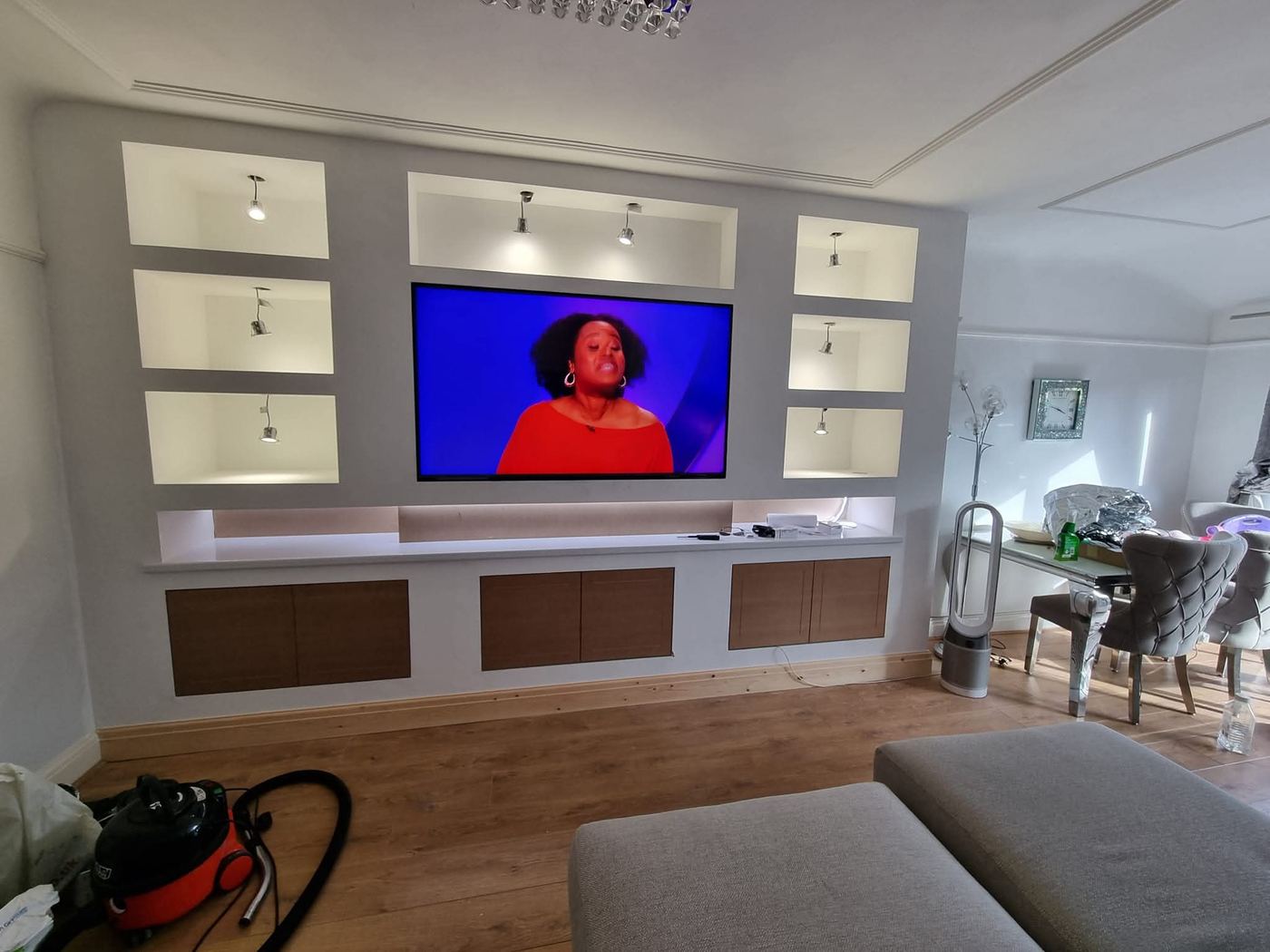 Media wall design with stacked illuminated shelving niches